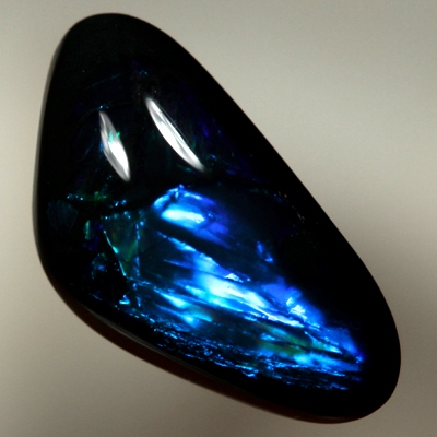 SOLID BLACK OPAL Rolling flashes of electric turquoise and peacock blue